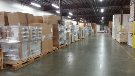 Large warehouse space with boxes on wooden palletes