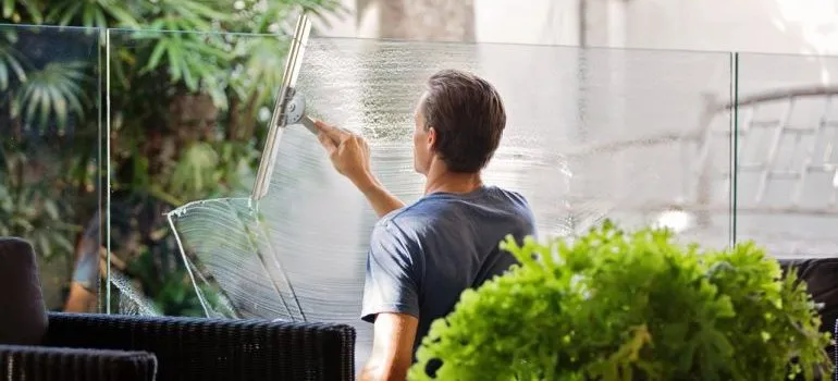 A man cleaning glass will help you cope with moving stress