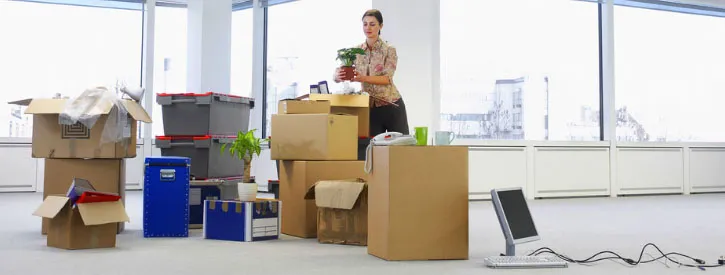 Woman with the boxes in the office
