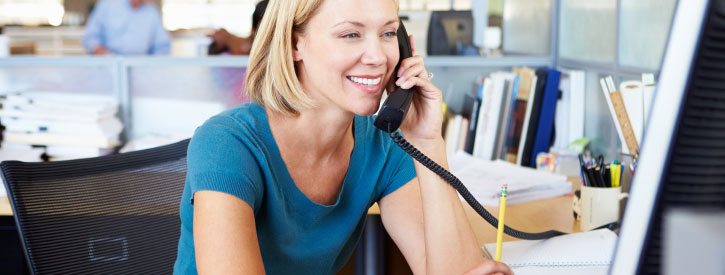 Woman in an office, talking on the phone