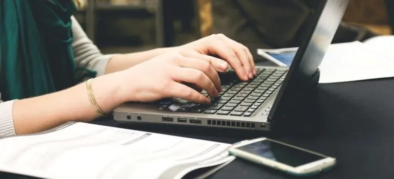 A person is typing on a laptop
