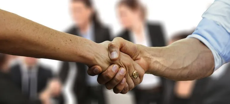 A handshake between freight companies Seattle representatives.