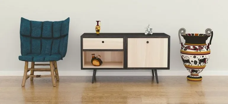 A chair, and end table, and a vase.