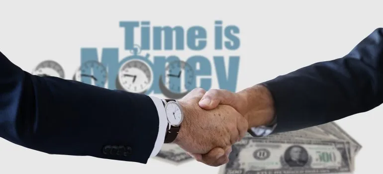 A handshake and a motivational quote in the background.