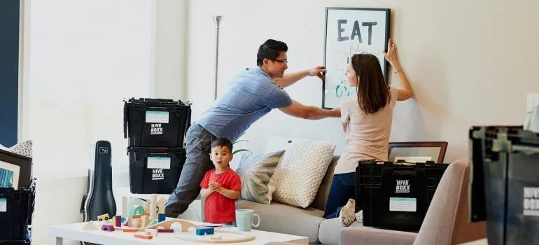 A couple taking a painting off the wall