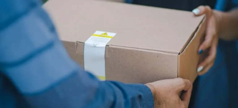 carrier taking a package from a customer