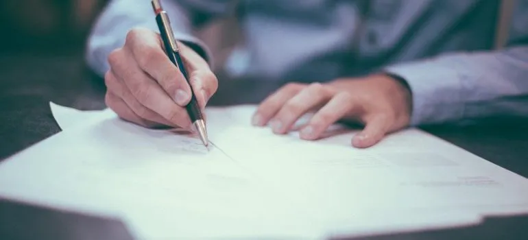 person filling a form for sending large packages internationally