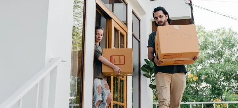 Couple carrying their boxes