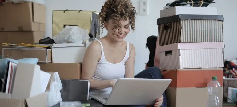 Woman surrounded by boxes.