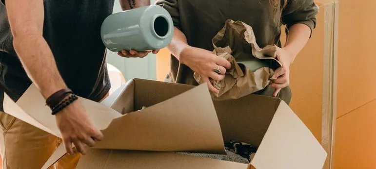 A couple packing moving boxes