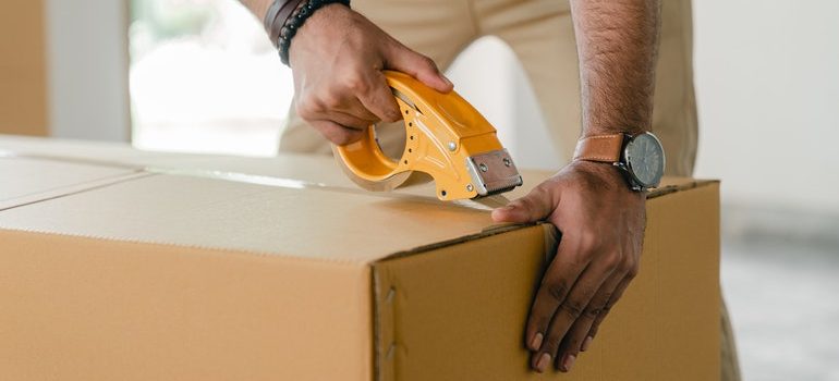 Man taping a box.