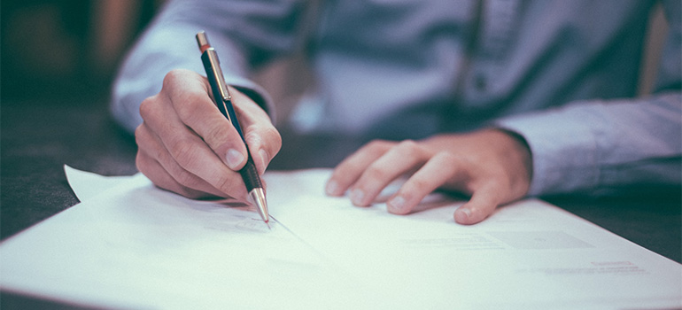A man that knows all about rights and responsibilities when you move signing a document