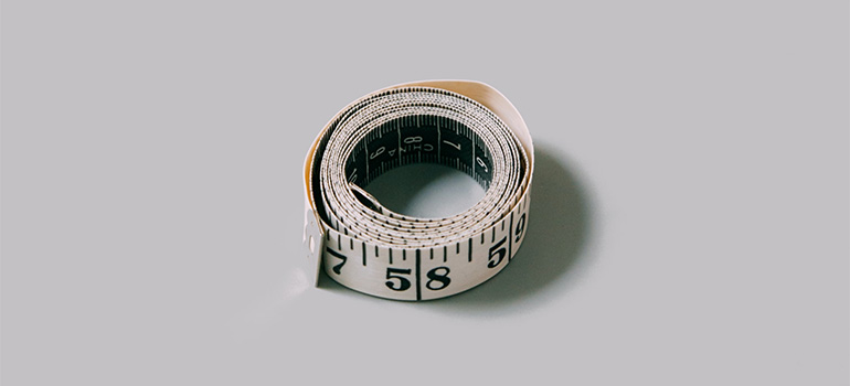 A rolled up white measuring tape that is a part of the useful solutions for moving furniture in Lynnwood