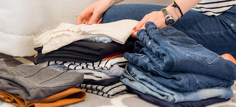 A woman sorting her clothing items