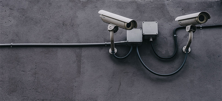 Security cameras on a gray wall
