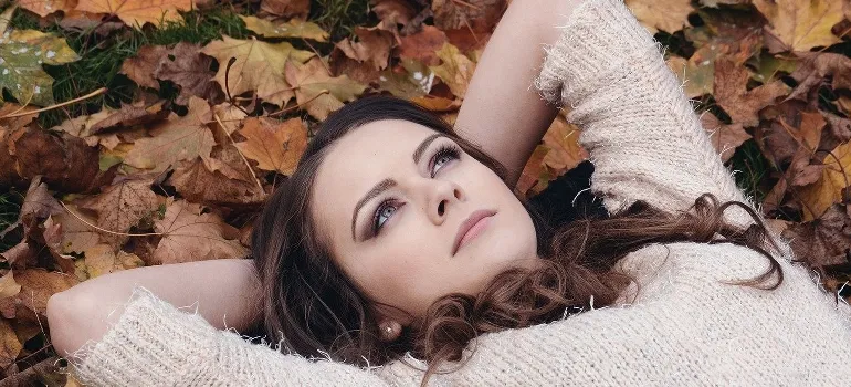 A woman lying on the ground dreaming about fun activities in Newcastle WA