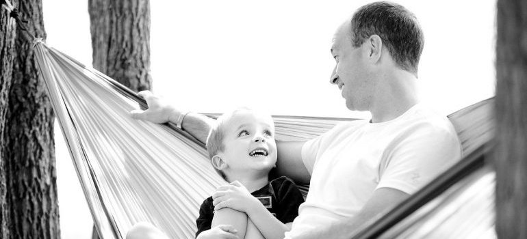 A black and white photo of a boy and his father.
