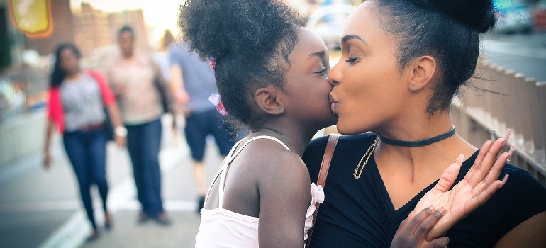 A mom and a daughter hugging on the street of Renton WA