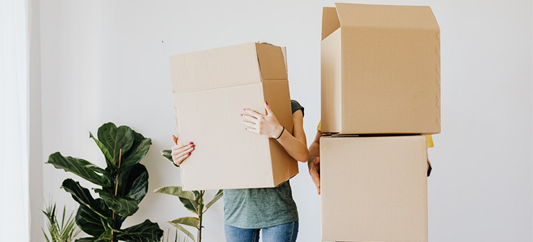 Two people holding boxes