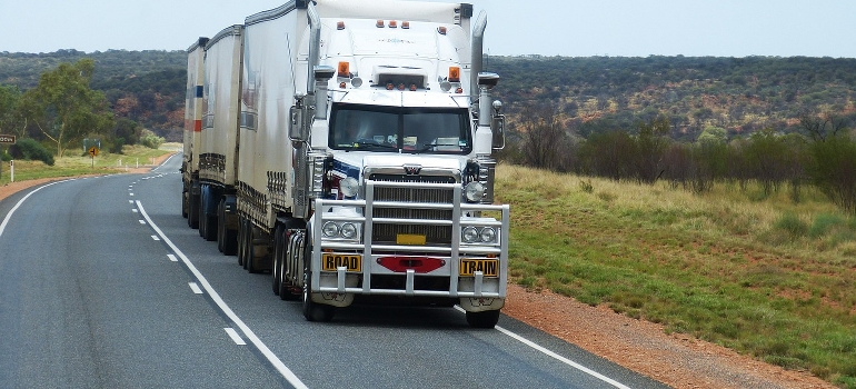 A large white truck on a road after calculating your move’s carbon footprint.