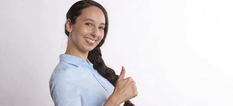 A woman giving a thumbs up gesture.