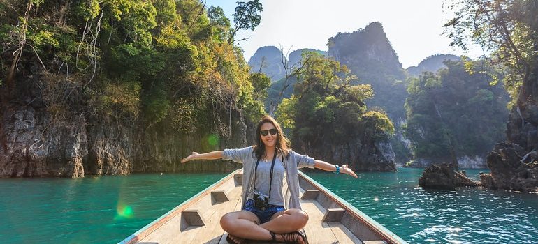 A woman posing while sitting on a boat