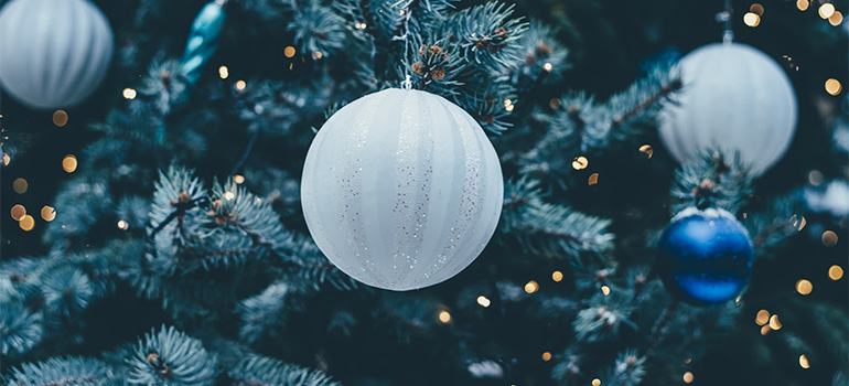 A Christmas tree with white ornaments