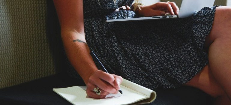 A woman writing in a notebook.