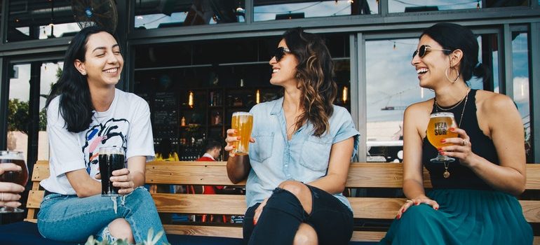 Three women drinking cocktails.