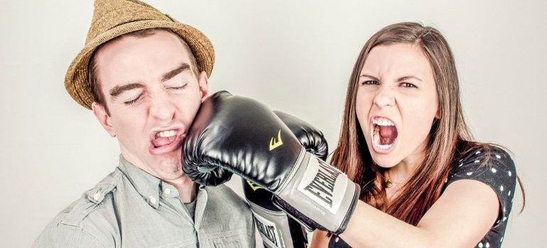 A couple arguing over the risks of living in a cluttered home.