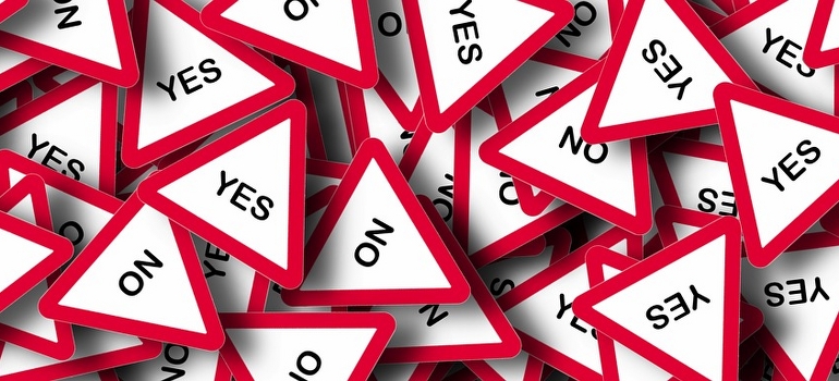 a pile of yes and know signs