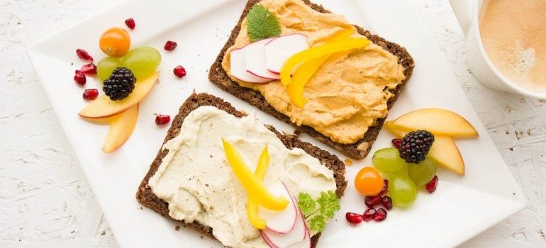 Hummus spread on bread and some fruit.