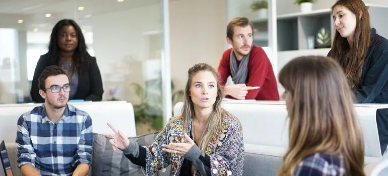 Employees talking about complications when moving a business.