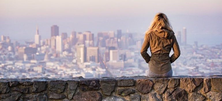 A woman looking at the city from a distance after moving to San Francisco.