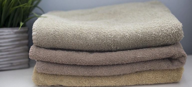 A stack of towels to use as sustainable moving ideas and solutions.