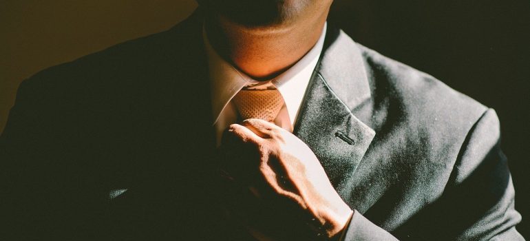 A man fixing his tie.