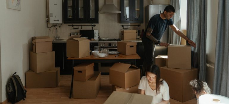 man and woman packing their kitchen