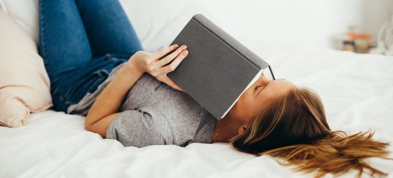 A woman having a nap during a relaxing reading session.