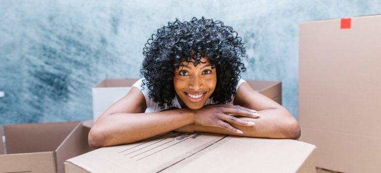 Woman around moving boxes