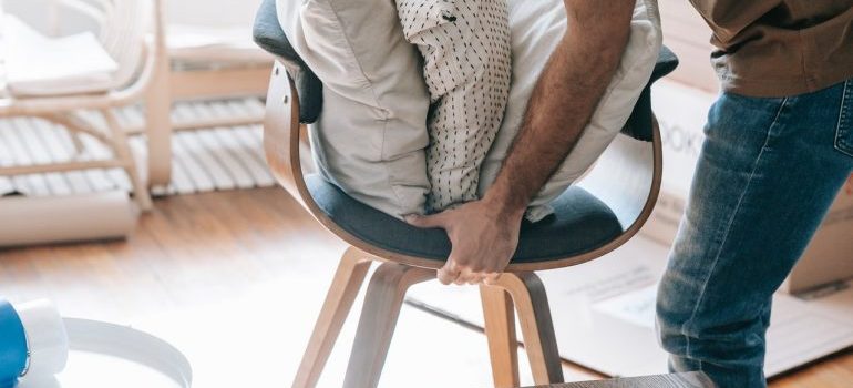 Man lifting a chair