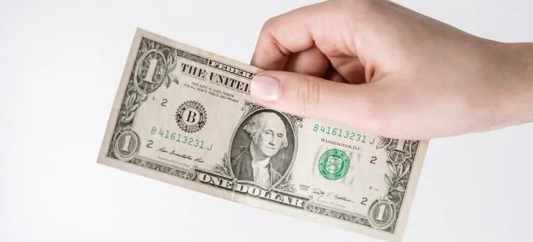 person holding a $1 bill