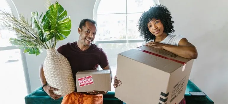 Couple unpacking after learning about organizing your home before unpacking