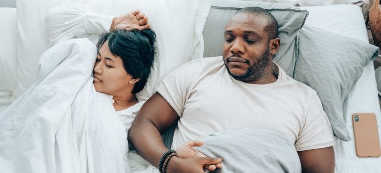 A couple sleeping while holding hands.