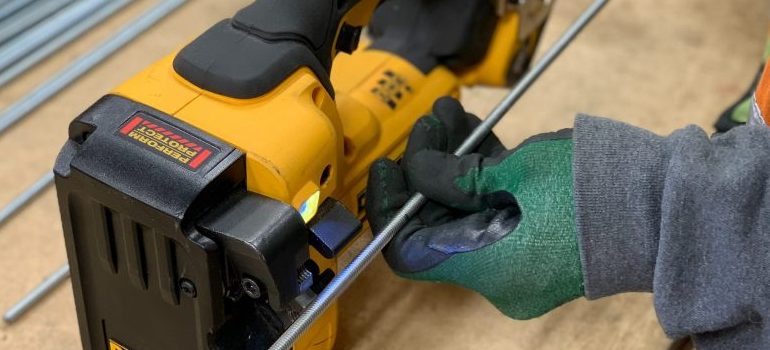 person packing your power tools for moving