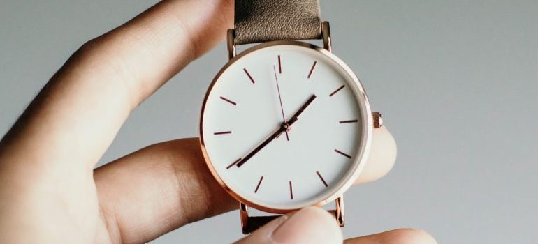 person holding a wrist watch