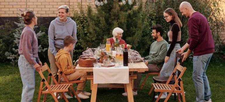 Family and friends eating in a backyard