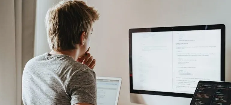 person looking at a TV screen, thinking