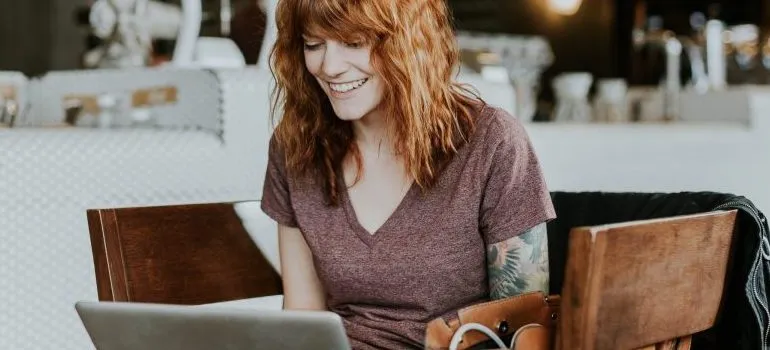 a woman sitting in a chair, smiling