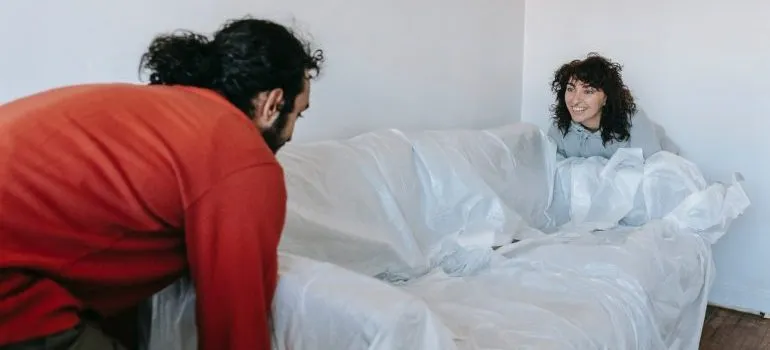 Couple moving a heavy couch