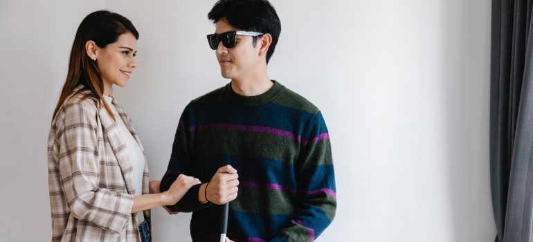 Woman helping a blind man
